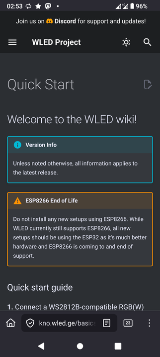 The image displays a mobile device screen with a dark background. At the top, there is a status bar showing the time as 02:53, 4G signal, and a battery level of 96%. Below the status bar, there is a header with the text "Join us on Discord for support and updates!" followed by the title "WLED Project" with a menu icon on the left and a search icon on the right. The main content area is titled "Quick Start" and welcomes users to the WLED wiki. There are two highlighted sections: "Version Info" in a blue box, stating that all information applies to the latest release, and "ESP8266 End of Life" in an orange box, advising against installing new setups using ESP8266 due to its end of support. The quick start guide begins with "1. Connect a WS2812B-compatible RGB(W)." At the bottom, there is a navigation bar with a home icon, a shield icon, and a search icon, along with a URL "kno.wled.ge/basics" and a notification count of 23.

Provided by @altbot, generated privately and locally using Ovis2-8B

🌱 Energy used: 0.274 Wh