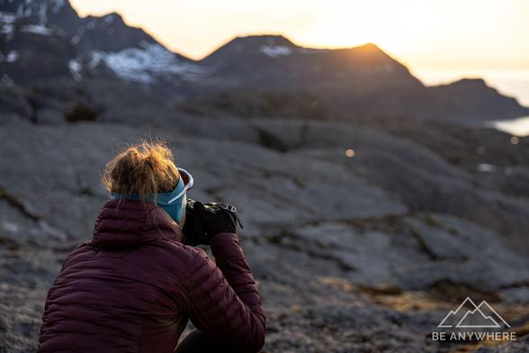 Woman with a camera capturing the sunset.