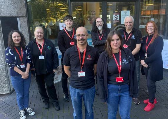 Group photo of eight Swansea Central Library staff preparing for the relocation from the Civic Centre to Y Storfa, the new community hub on Oxford Street.