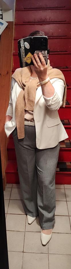 Beige shell, grey wide-leg trousers, white blazer, beige sweater as scarf. White belt, slingbacks, and jewelry.
