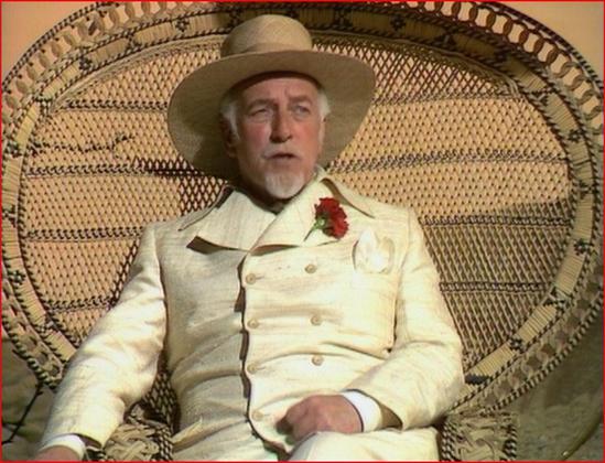 Screenshot of the White Guardian sitting in a wicker chair, from Doctor Who