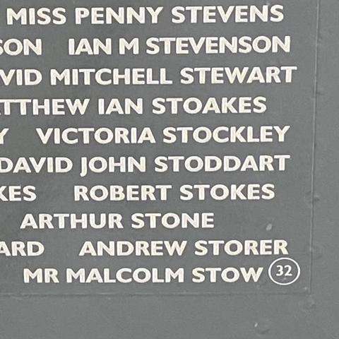 Grey panel on the underside of the Vulcan's starboard wing, engraved with names in white, including "Robert Stokes".