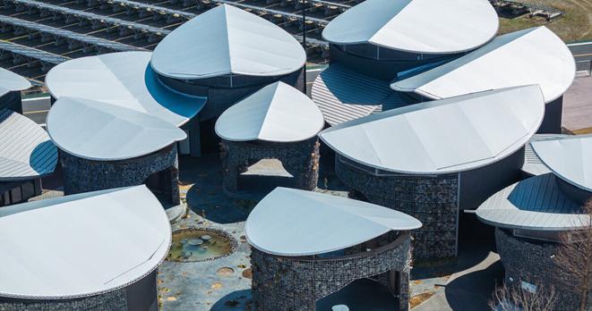 gabion walled-pavilion encircles biodiverse courtyard at osaka expo
