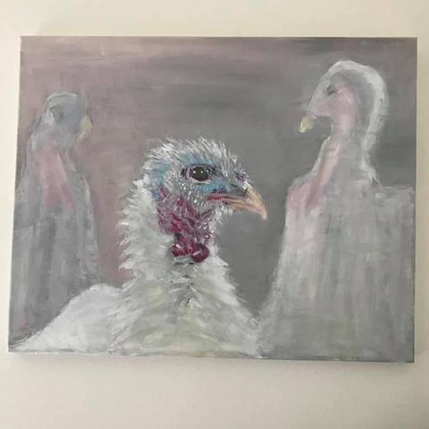 a turkey head with colors blue red and grey/white. Behind stylized two other turkeys.