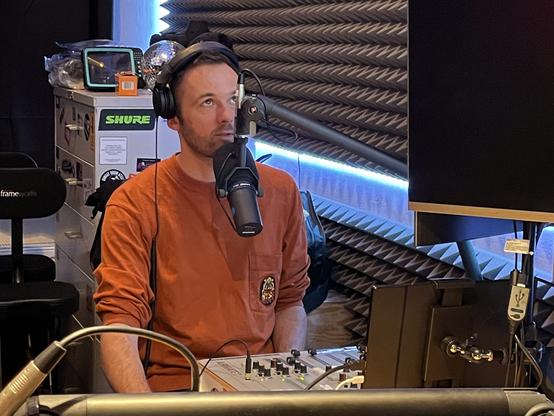 I am looking up into the monitor screen, reading into the mic with a concentrated expression