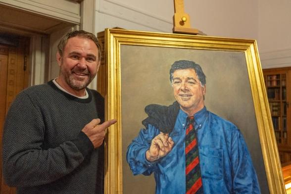 Scott Quinnell points at a portrait during his visit to the National Library of Wales while tracing his family story for S4C’s Cyfrinachau’r Llyfrgell.