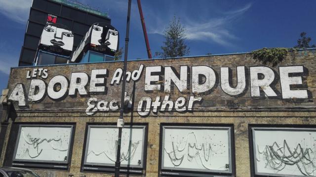 Graffiti in London stating that we should adore and endure one another