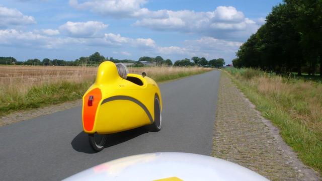 Going for a ride along a country road, the velomobile which is for sale as it's seen from my own velomobile when riding just behind.