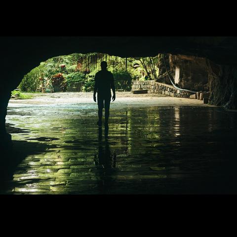 Silhouette of a man coming out of a cave in Ninh Binh in Vietnam