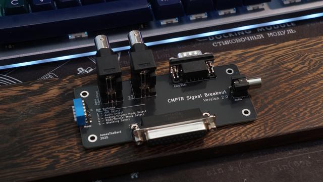 The CMPTR breakout board fully assembled with RGBS BNC connectors, a DB9 port for CGA, and more than a couple of DIP switches for settings.