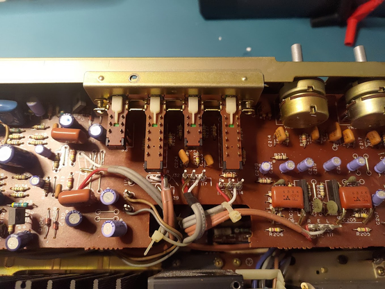 A Technics SU-8080 tone PCB. There is a lot of dirt everywhere and all the cables are soldered in instead of being plugged as a slightly more modern (late 80s) amp would have.