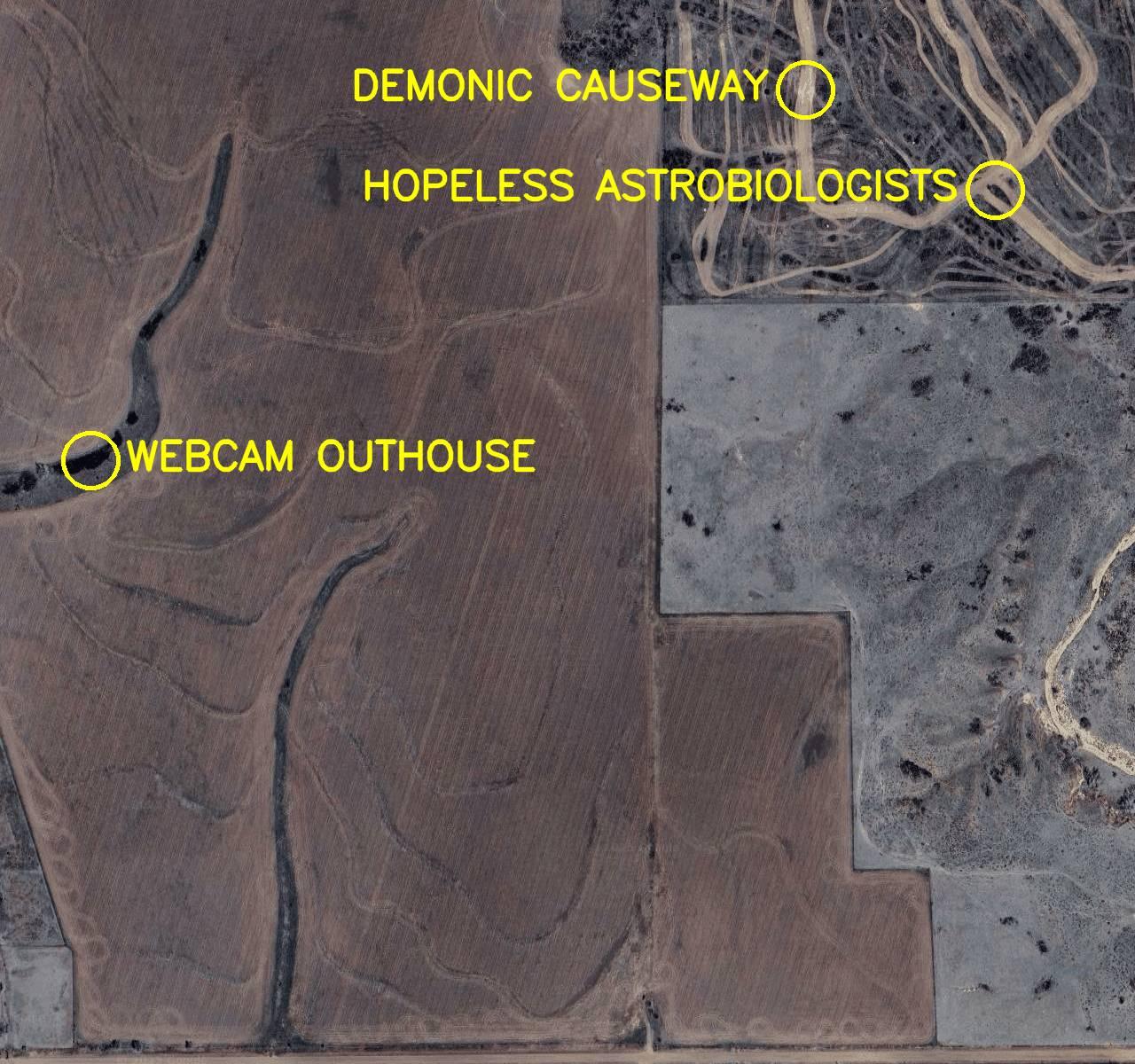 Aerial satellite photo labelled in bright yellow letters:  1. Demonic Causeway 2. Webcam Outhouse 3. Hopeless Astrobiologists