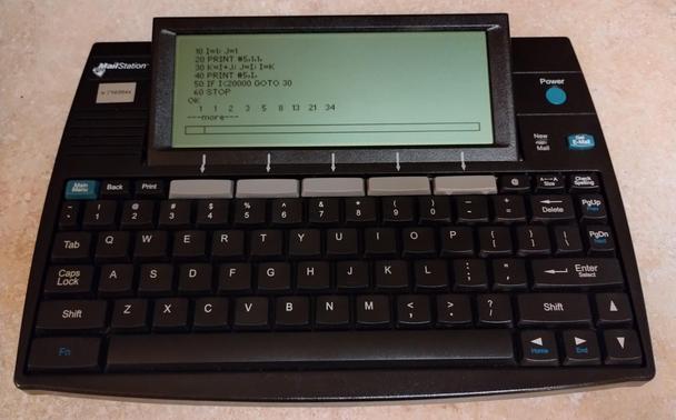 Cidco MailStation displaying a BASIC listing that calculates Fibonacci numbers.
The program is then run and results displayed: 1 1 2 3 5 8 13 21 34 ...