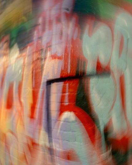 Some red and grey graffiti letters with the centre fairly sharp but a swirling effect expanding out