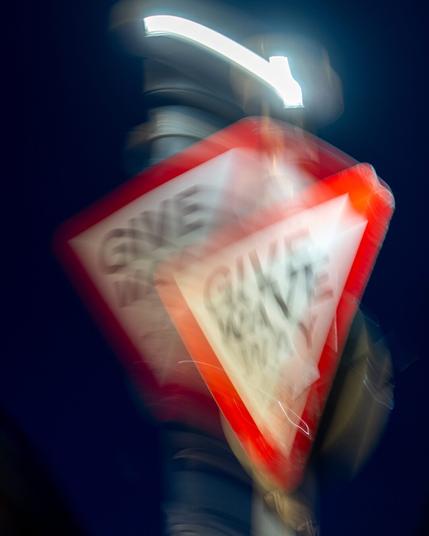 A give way sign looking like its double exposured