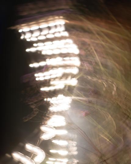 A string of lights blurred looking like a DNA twist