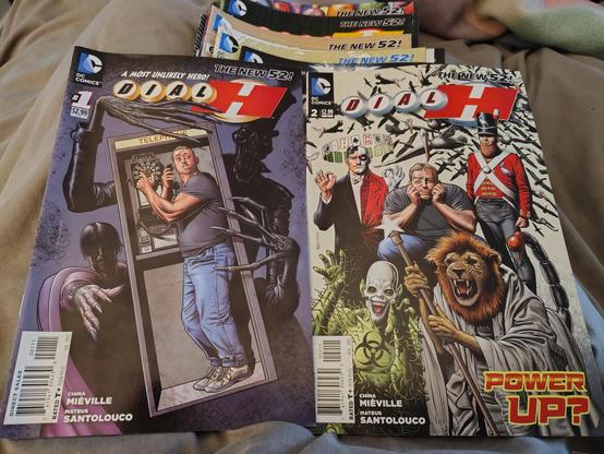 A stack of 'Dial H' comics. The visible covers credit China Miéville and Mateus Santolouco.