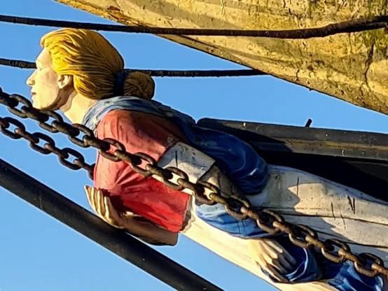 A figurehead on the prow of a tall ship.
