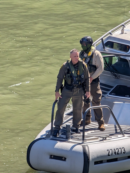 U.S. Customs and Border Protection Commander of Operations At Large Greg Bovino stands at the front of a CPB boat in the Chicago River near the Lake Street bridge shortly before 1 p.m., Thursday.
