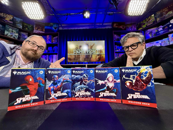 Nelson and Cameron sitting on the AFK set behind the 5 Spider-Man welcome decks.
