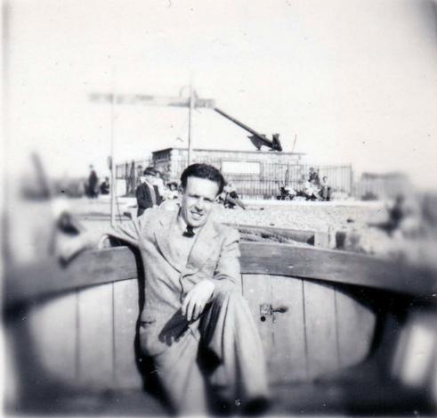 Jack sits in what looks like a boat, smiling for the camera. In the background, the Battle of Trafalgar memorial can be seen, with HMS Victory's anchor a dominant feature on top of the plinth.