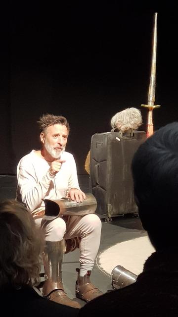 Real photograph. Dik Downey on stage putting on his armour in the opening of  "Don Quixote (is a very big book)". Real photographer: me.