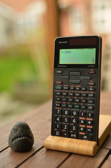 Sharp EL-W506T calculator next to a grumpy lump.