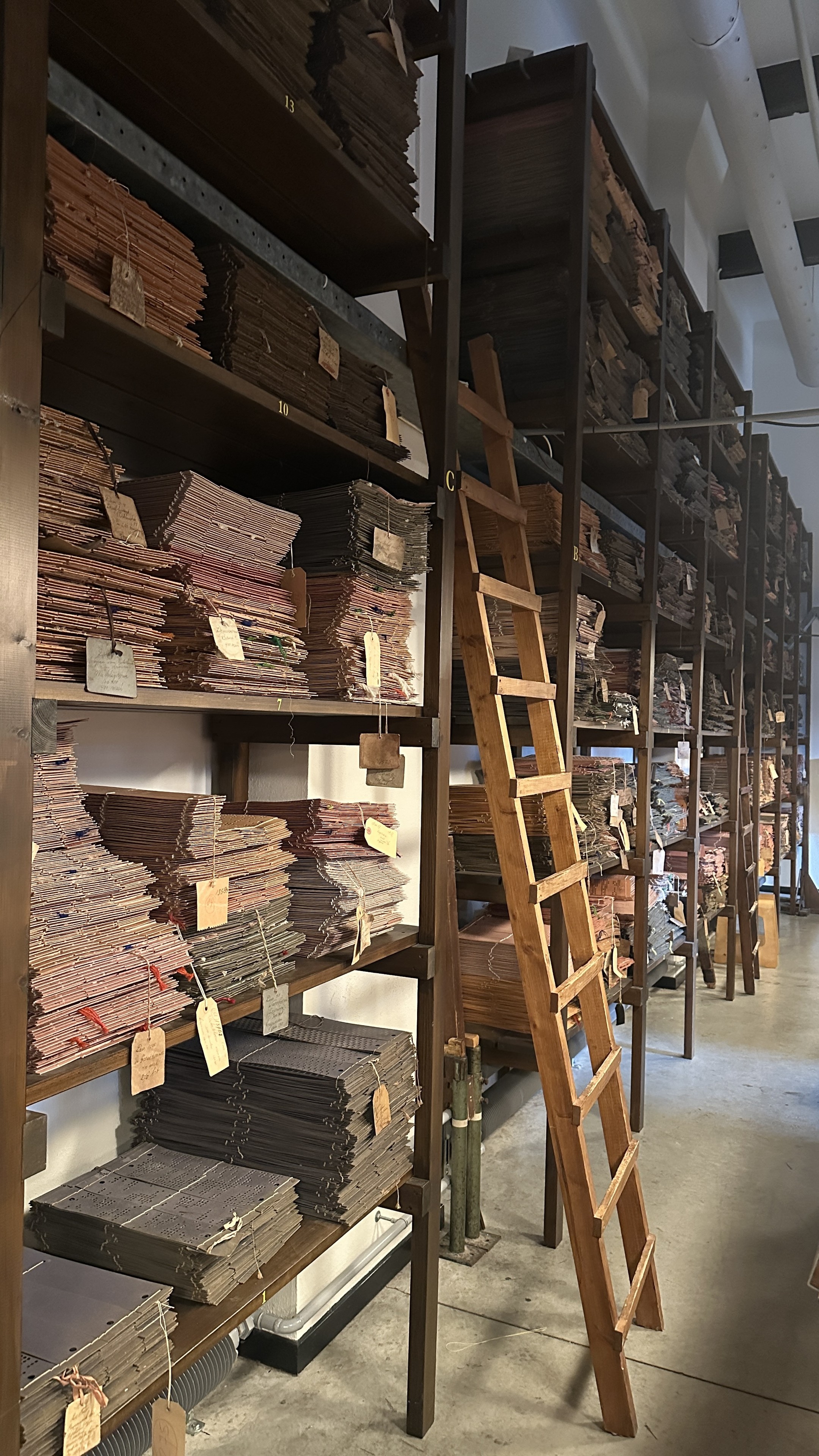 Long series of shelves filled with punch cards for looms