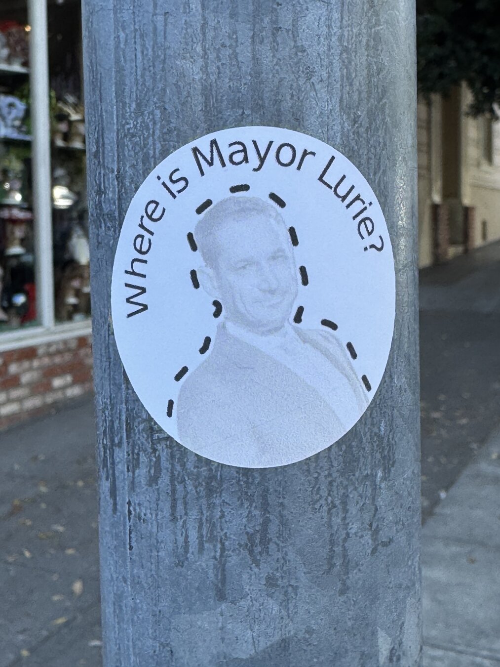 A sticker that says "Where is Mayor Lurie" and shows a photo of Daniel Lurie.
