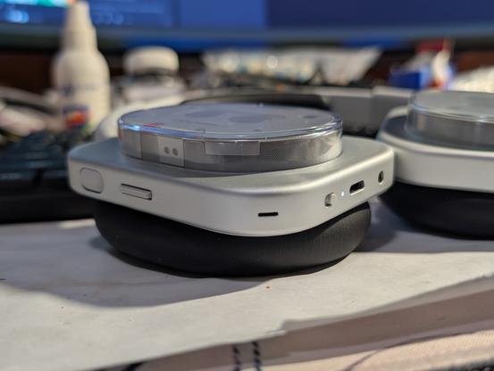 Headphone (1) on the table from the side (view on the controls).