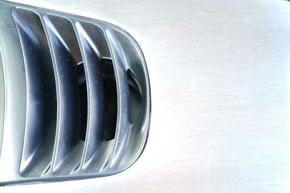 Photo: brushed aluminium car panel with air vent taking up most of left hand side of image