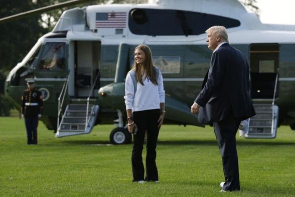 WASHINGTON, DC: US President Donald Trump and his granddaughter, Kai Trump, walk to Marine One on the South Lawn of the White House as they prepare to depart September 26, 2025 in Washington, DC. -- AFP