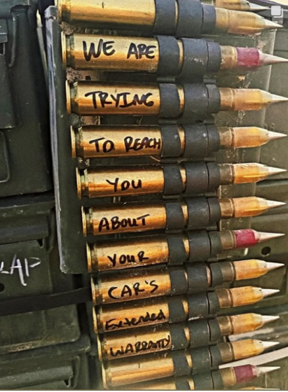 A chain of bullets with a message written on the casings that reads "We are trying to reach you about your car's extended warranty" lolz