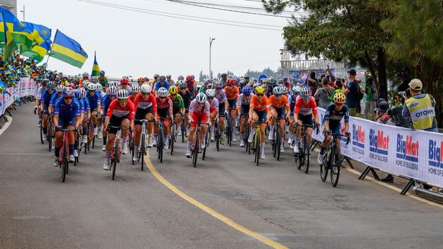 Women cyclists competing in the UCI Women’s Elite Road Race at the World Championships in Kigali, with spectators cheering from the roadside.