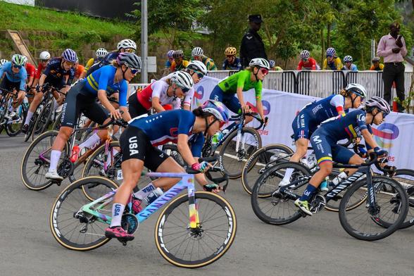 Women cyclists competing in the UCI Women’s Elite Road Race at the World Championships in Kigali, with spectators cheering from the roadside.