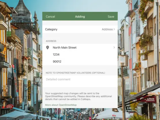 Screenshot of CoMaps app where address is added, and a picture of a lively city street in the background.
