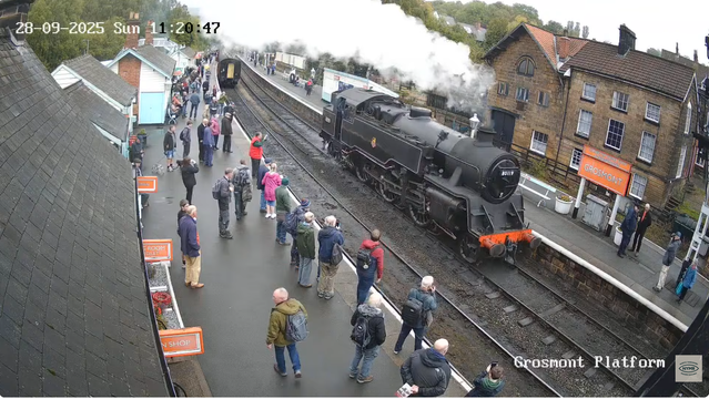 Steam locomotive driving out along platform 3, having left the carriages on platform 2. North Yorkshire Moors Railway, Grosmont