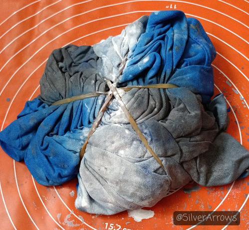 Round 2. The t-shirt is spiralled and bound with rubber bands. I've applied primary cyan, white and grey (no silver) to the t-shirt.