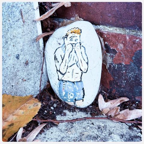 A small pebble with a paining of Paul Gascogne