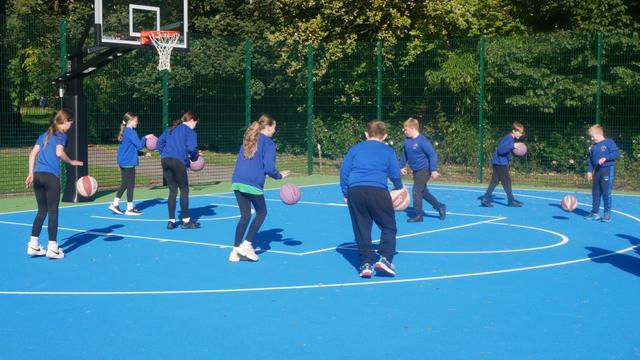 Children playing basketball on the newly opened court at Maesteg Welfare Park, part of Bridgend’s £82,500 investment in accessible multi-sport infrastructure.