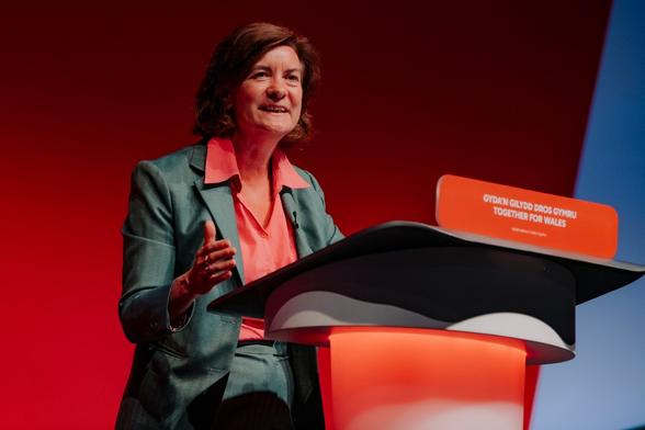Eluned Morgan addressing the Labour Party conference from the lectern, outlining Welsh Labour’s vision for stability and delivery ahead of the Senedd election.