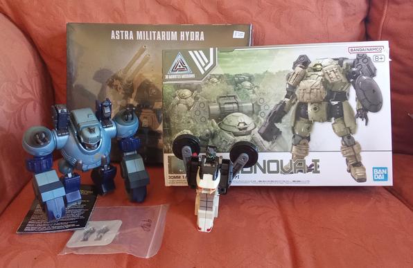 A selection of model kits and toys on a sofa.