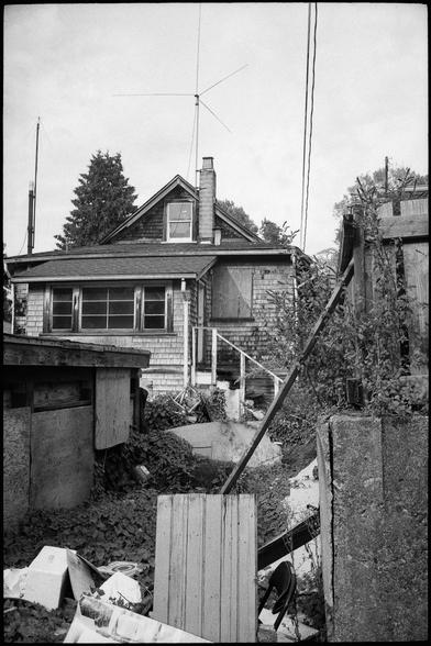 A dilapidated suburban home from the back alley.