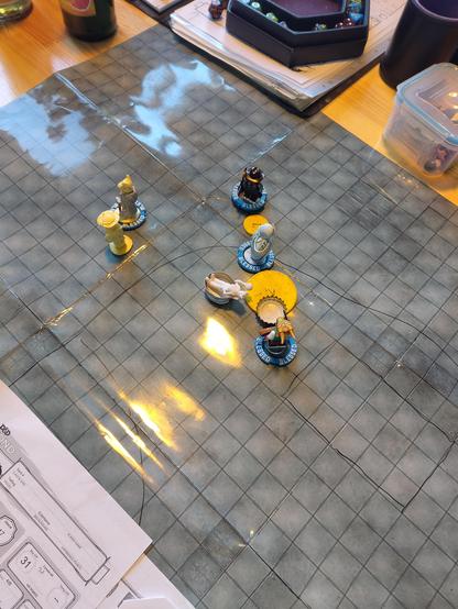 Dungeons and Dragons Battle map with 5 miniatures in a conga line battling each other.