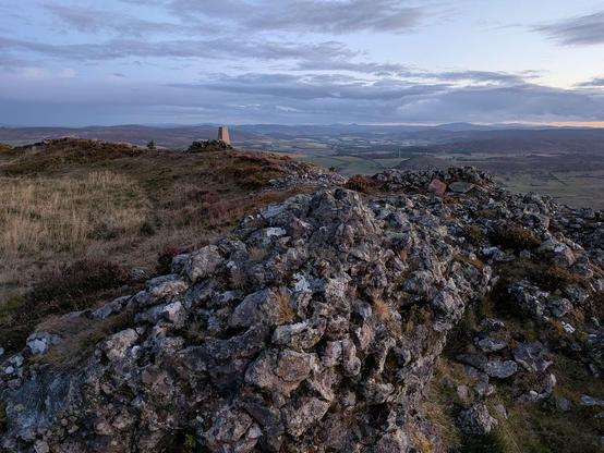 Photo of Tap o' Noth hill fort at the top of the hill. Second highest in Scotland. The walls are vitrified.
