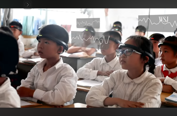 Fifth-graders in a Chinese classroom wearing electronic headsets with EEG readouts.