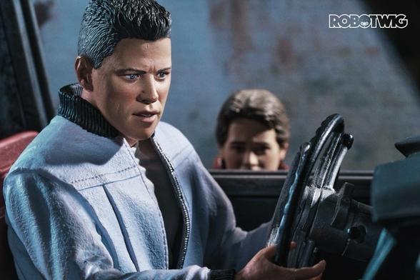 Biff Tannen drives his car through the tunnel listening to sports channel. Marty can be seen sneaking outside the car trying to get the Almanac