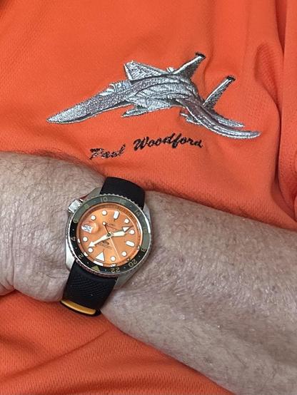 wristwatch against embroidered shirt