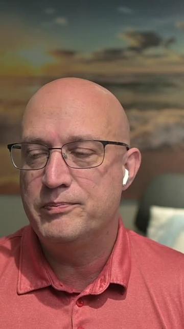 Image of character Jerry Bell played by Jerry Bell from the podcast "Defensive Security".
A stern-looking bald white man with a heroic nose is show in partial light. He is wearing a salmon shirt and has electronic devices attached to his ears.