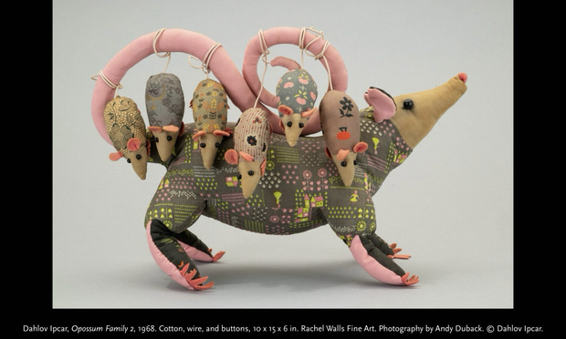 Official photo of the object in side profile on white background, with caption. Soft sculpture of a mother opossum with six babies hanging off her tail (held up curving over her back) by their own tails. Primarily naturalistic coloration but with the grey body fabrics decorated with various patterns.  “Dahlov Ipcar, Opossum Family 2, 1968. Cotton, wire, and buttons, 10 x 15 x 6 in. Rachel Walls Fine Art. Photography by Andy Duback. © Dahlov Ipcar.”